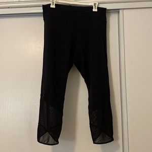 Black Lululemon leggings, sheer detail on waist and by ankles